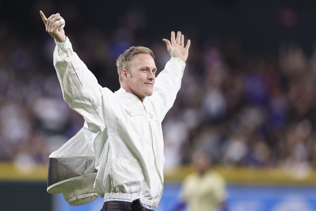 Beekeeper Matt Hilton reacts to fans before throwing out the ceremonial first pitch.