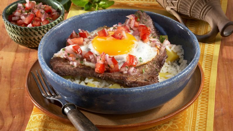 Bolivia: Silpancho brings together rice and potatoes with meats, a fried egg and salsa.