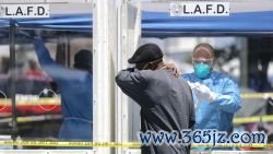 LOS ANGELES, CALIFORNIA - APRIL 21: A man is asked to cough into his arm as part of testing for COVID-19, by a member of the Los Angeles Fire Department wearing personal protective equipment (PPE) in Skid Row, amidst the coronavirus pandemic on April 21, 2020 in Los Angeles, California. 43 people tested positive for COVID-19 at one nearby Skid Row homeless shelter. (Photo by Mario Tama/Getty Images)